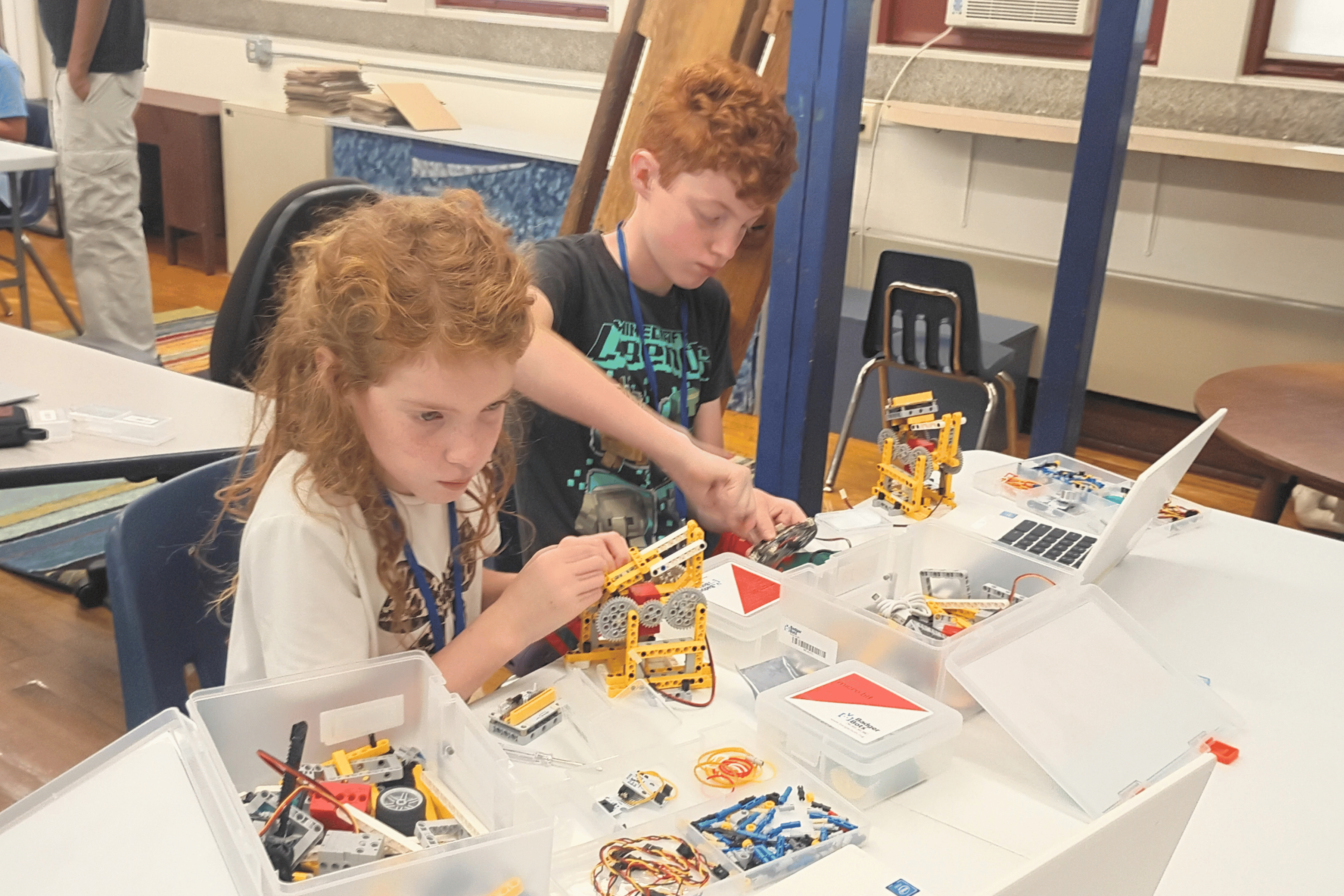 Summer campers build micro:bit robots.