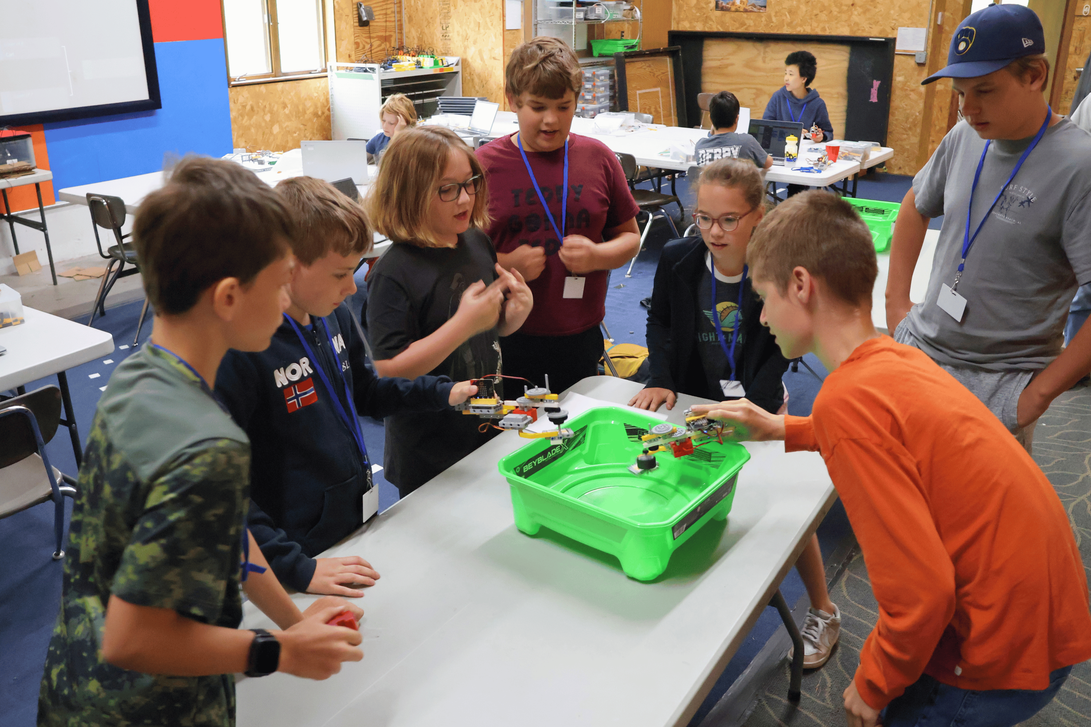 Summer campers play with the Beyblade launchers they built and programmed with micro:bit robots.