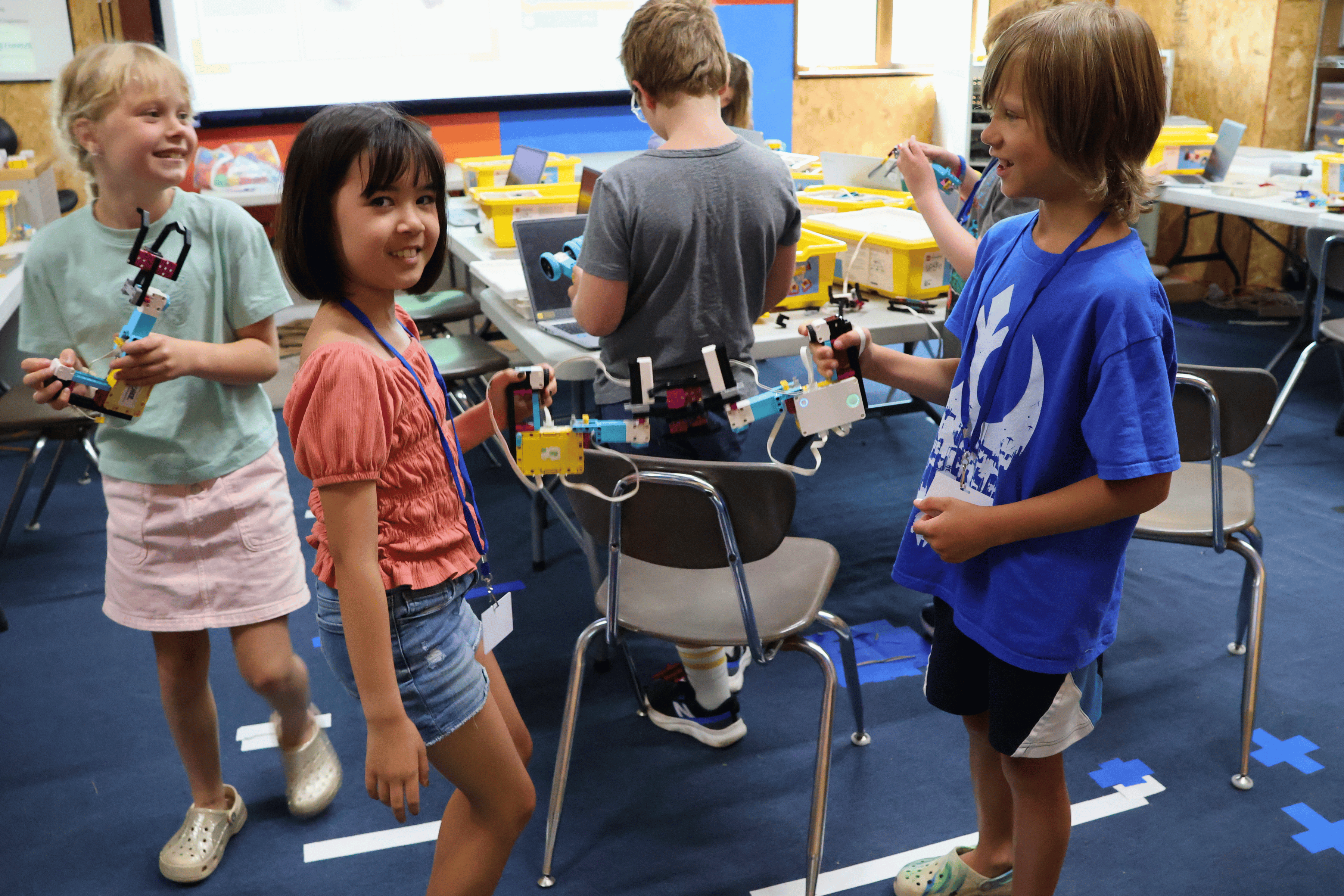 Summer campers play with the LEGO robotic "hands" they built and programmed.