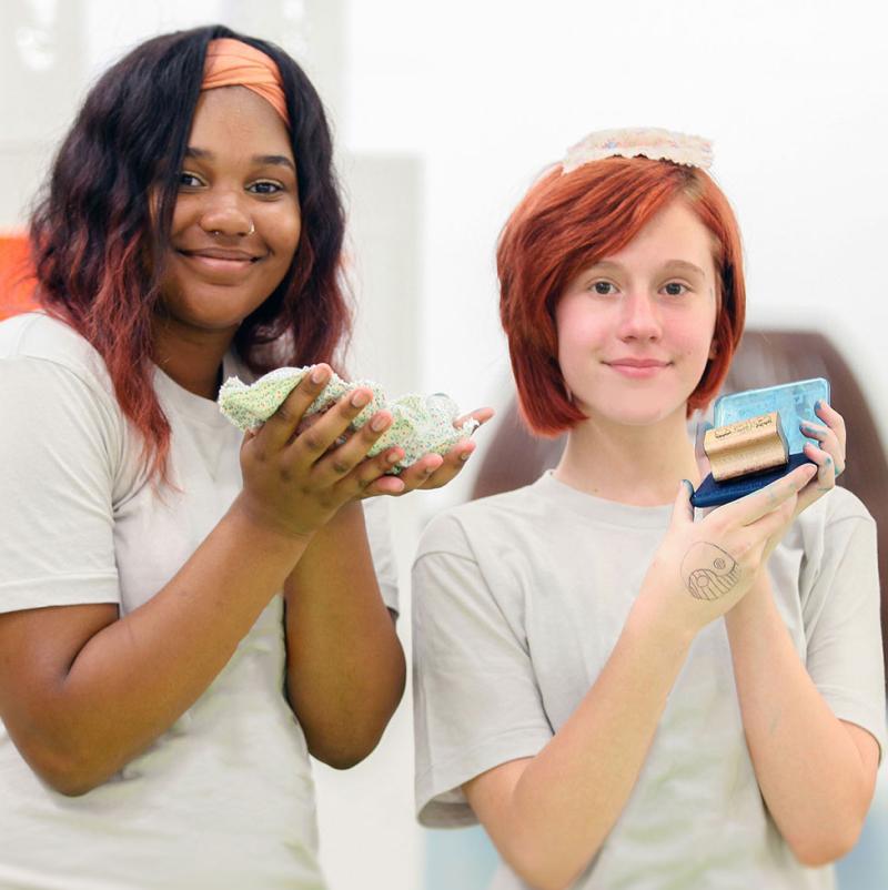 Two teenagers working on crafts